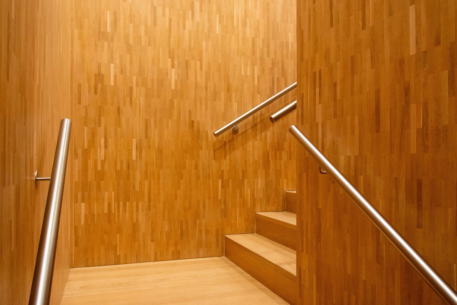 Modern wooden staircase with metal railings